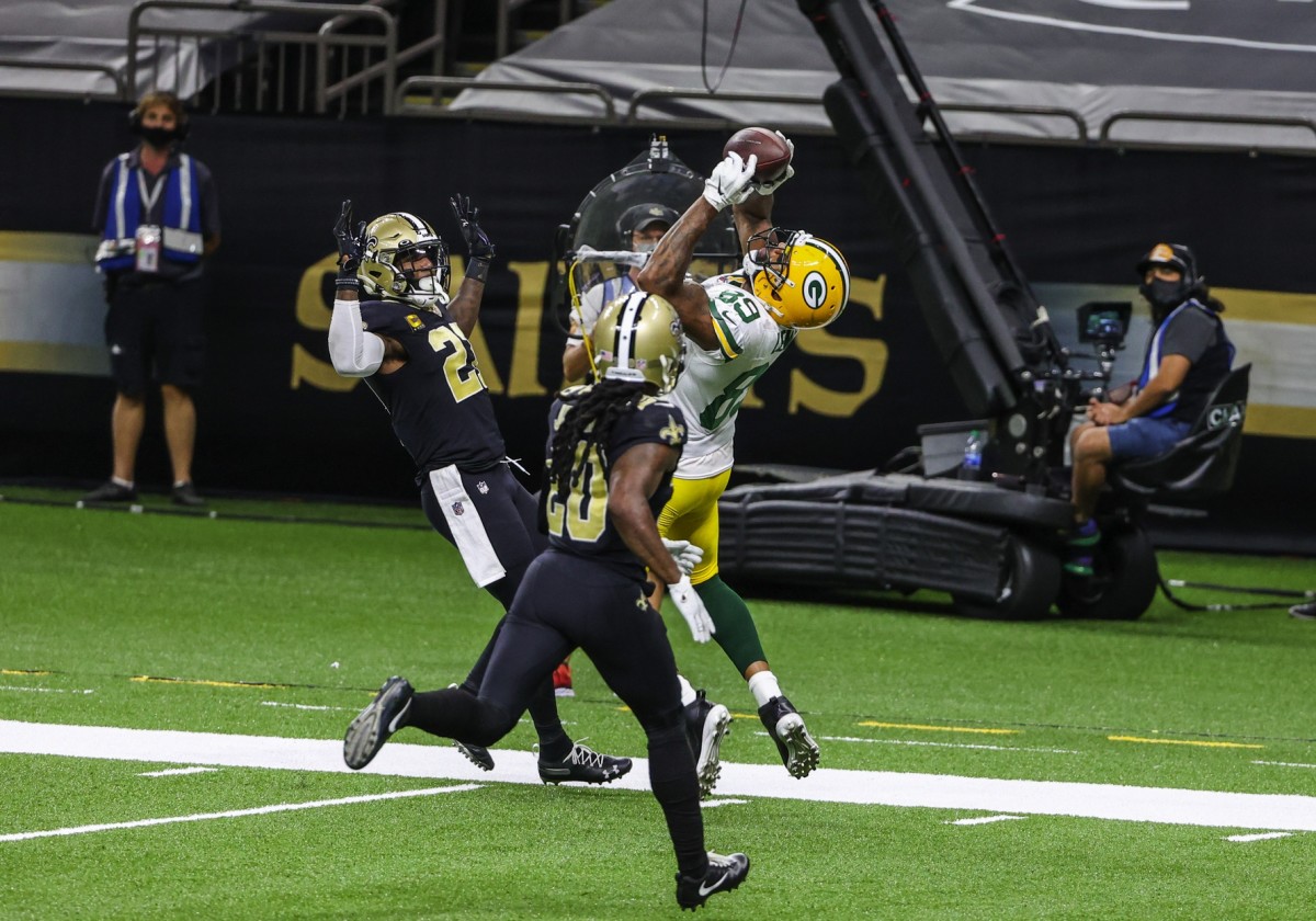 Sep 27, 2020; New Orleans, Louisiana, USA; Green Bay Packers tight end Marcedes Lewis (89) catches a touchdown over New Orleans Saints cornerback Janoris Jenkins (20) and safety Malcolm Jenkins (27) during the second half at the Mercedes-Benz Superdome. Mandatory Credit: Derick E. Hingle-USA TODAY