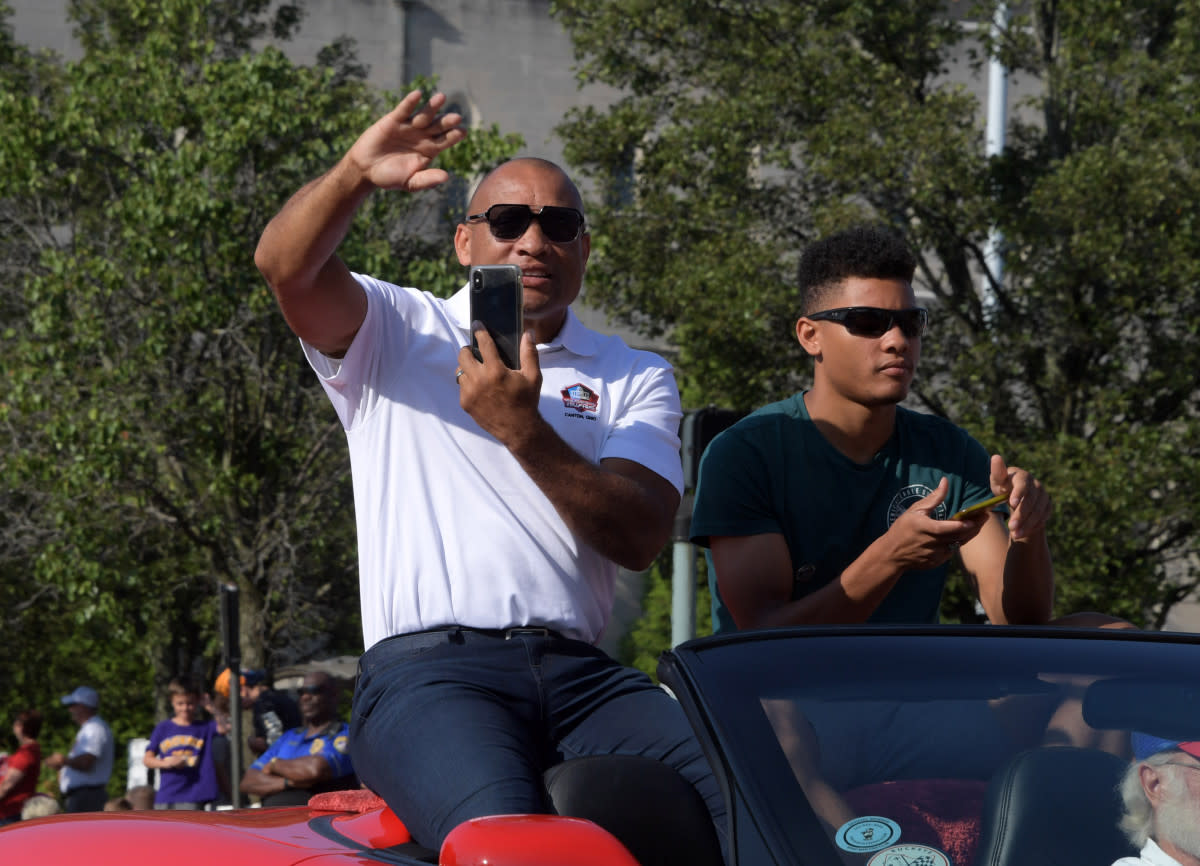 Aeneas Williams and son Lazarus Williams react during the 2019 Pro Football Hall of Fame Grand Parade on Cleveland Avenue in Downtown Canton.