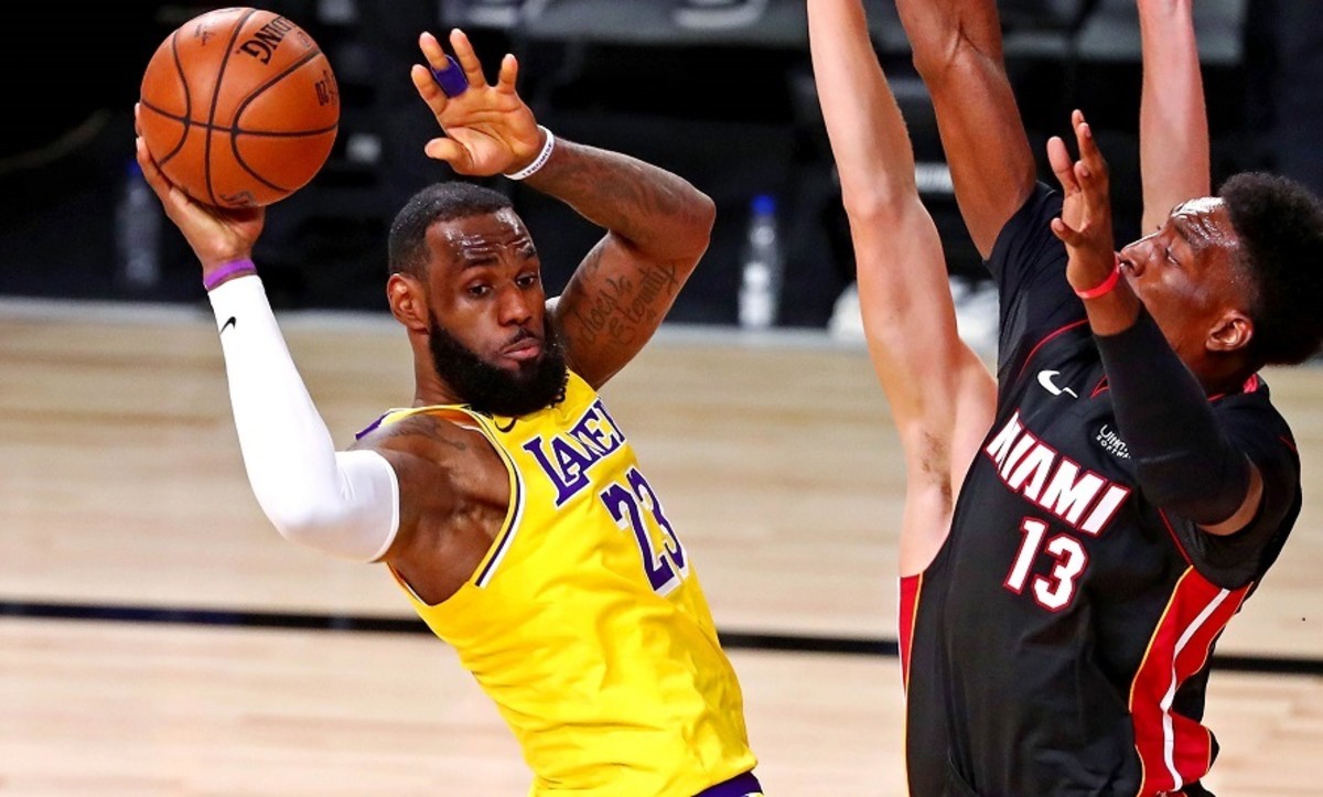 Los Angeles Lakers forward LeBron James (23) passes the ball against Miami Heat forward Bam Adebayo (13) during the third quarter in game one of the 2020 NBA Finals at AdventHealth Arena.
