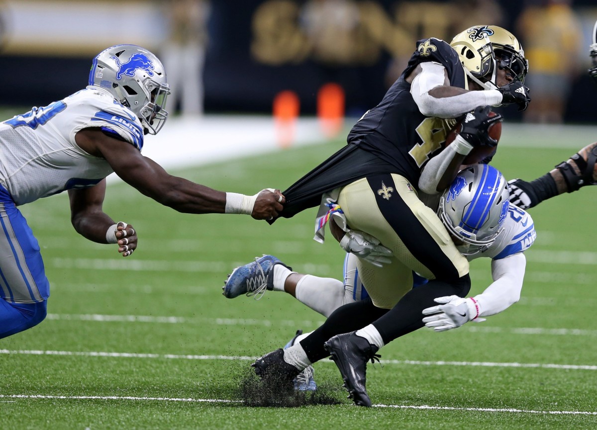 Oct 15, 2017; New Orleans, LA, USA; Detroit Lions linebacker Jarrad Davis (40) and cornerback Quandre Diggs (28) tackle New Orleans Saints running back Alvin Kamara (41) in the second half at the Mercedes-Benz Superdome. Mandatory Credit: Chuck Cook-USA TODAY
