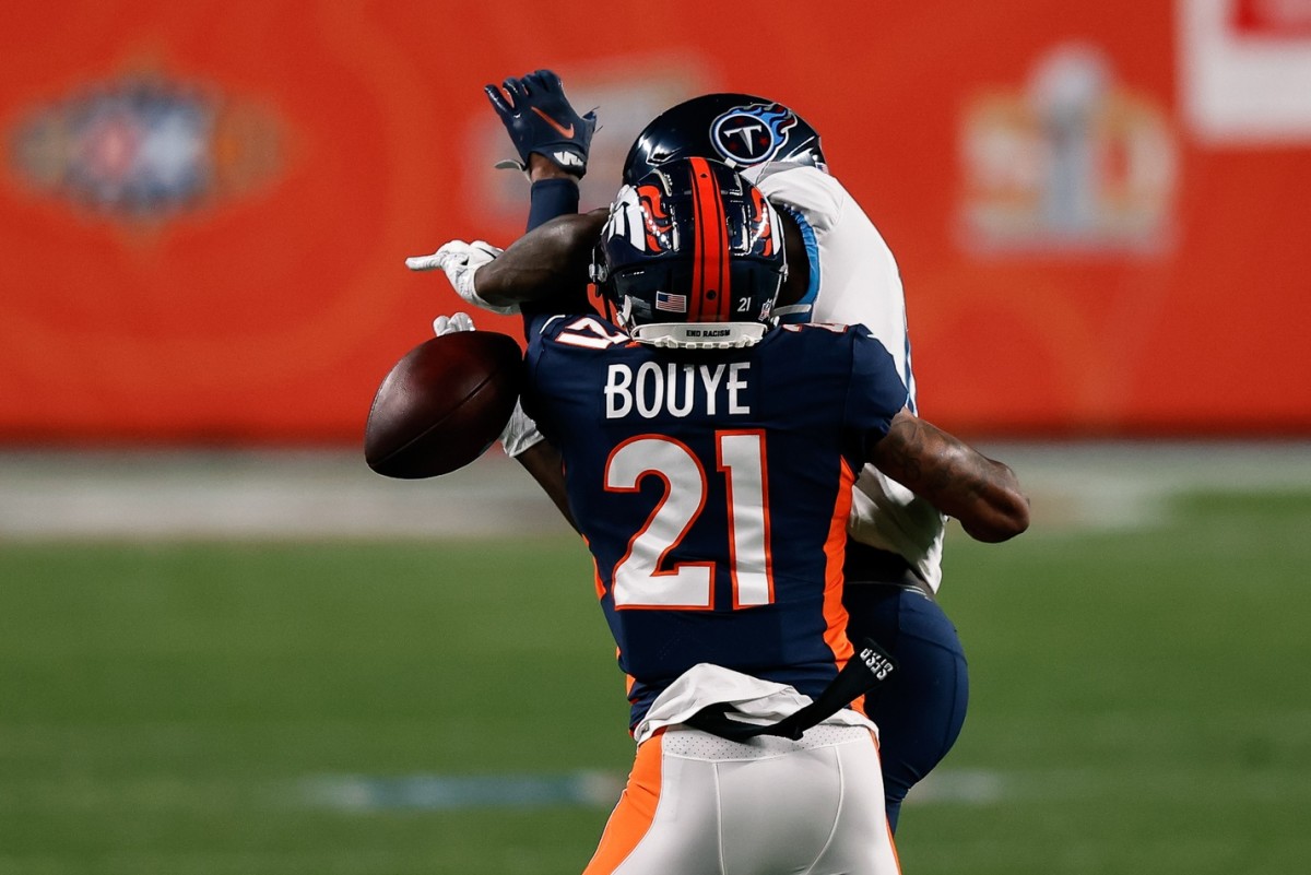 Denver Broncos cornerback A.J. Bouye (21) breaks up a pass intended for Tennessee Titans wide receiver A.J. Brown (11) in the first quarter at Empower Field at Mile High.