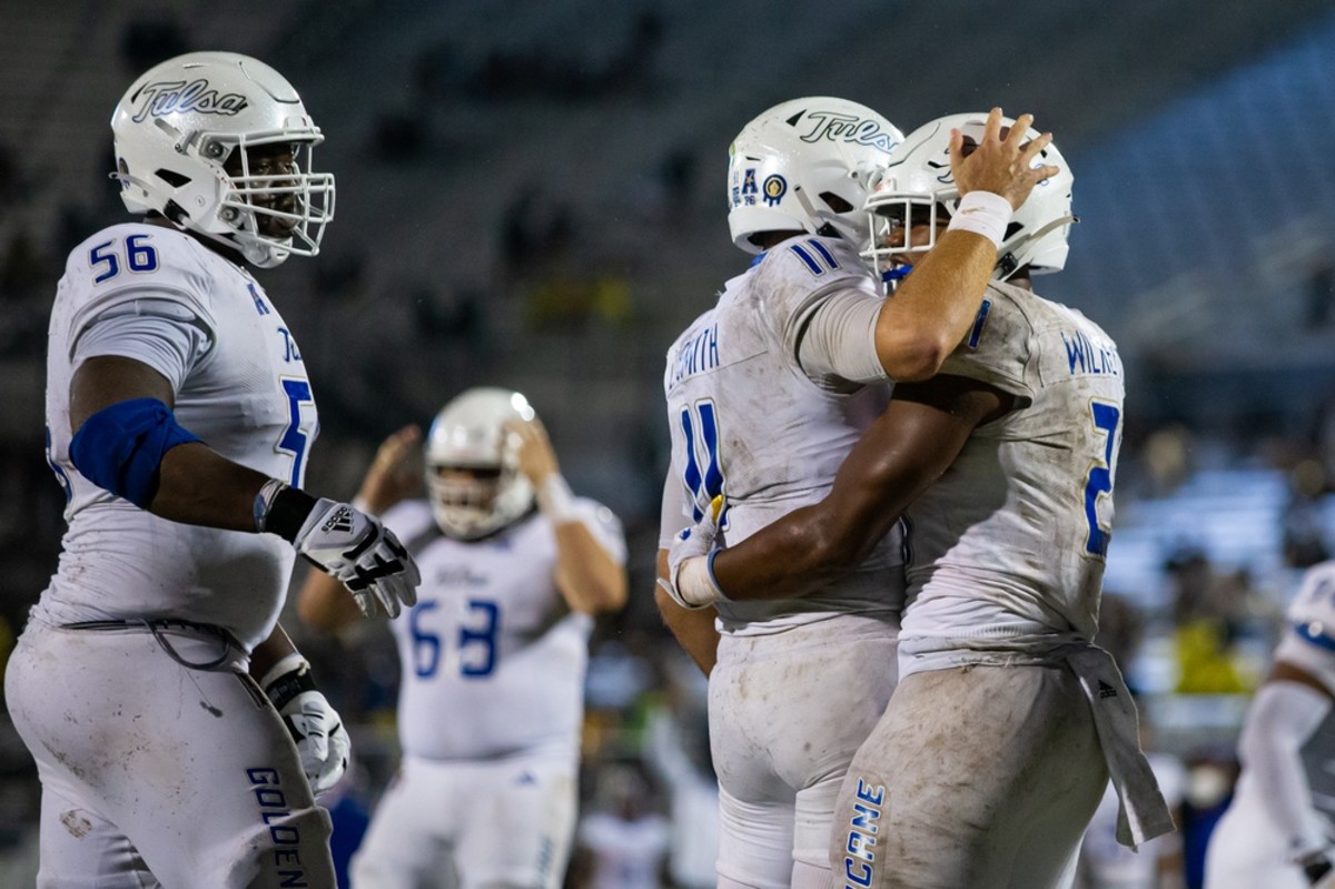 Tulsa running back T.J. Wilkerson (2) celebrates with quarterback Zach Smith (11) after scoring a third quarter touchdown in Tulsa's 34-26 upset over No. 11 Central Florida. 