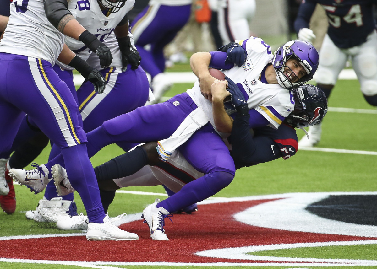 Minnesota Vikings quarterback Kirk Cousins (8) is sacked by Houston Texans outside linebacker Whitney Mercilus (59) during the first quarter at NRG Stadium.