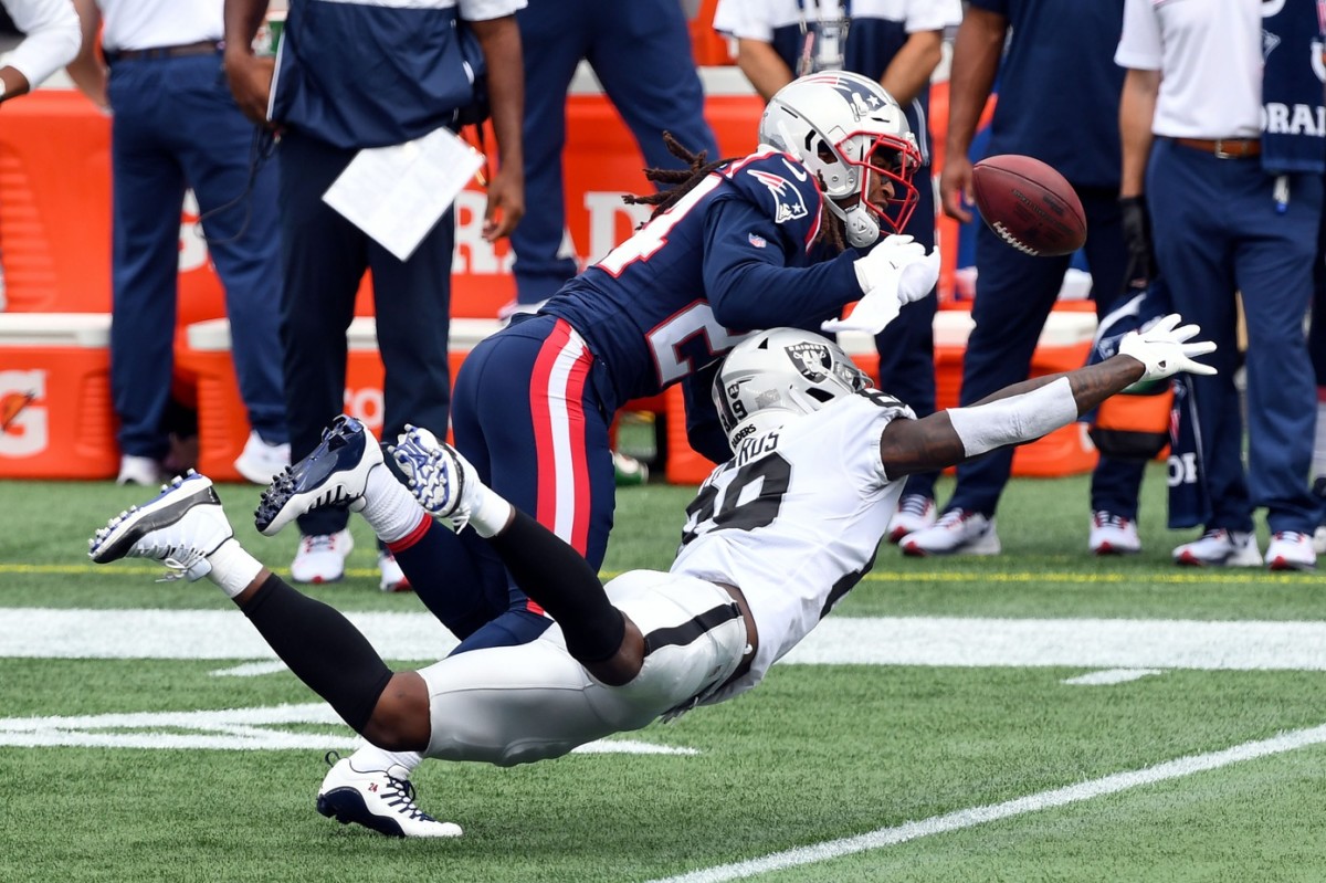 Sep 27, 2020; Foxborough, Massachusetts, USA; New England Patriots cornerback Stephon Gilmore (24) breaks up a pass intended for Las Vegas Raiders wide receiver Bryan Edwards (89) during the first quarter at Gillette Stadium. Mandatory Credit: Brian Fluharty-USA TODAY Sports