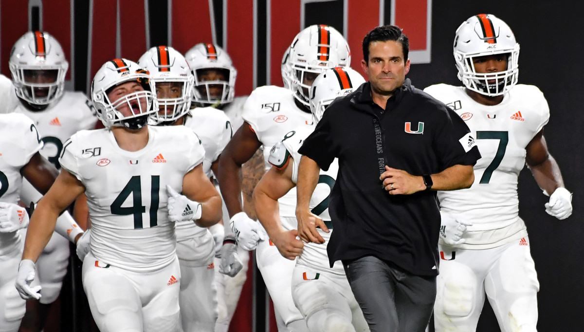 Miami Hurricanes head coach Manny Diaz runs out of the tunnel before the second half against the Virginia Cavaliers at Hard Rock Stadium.