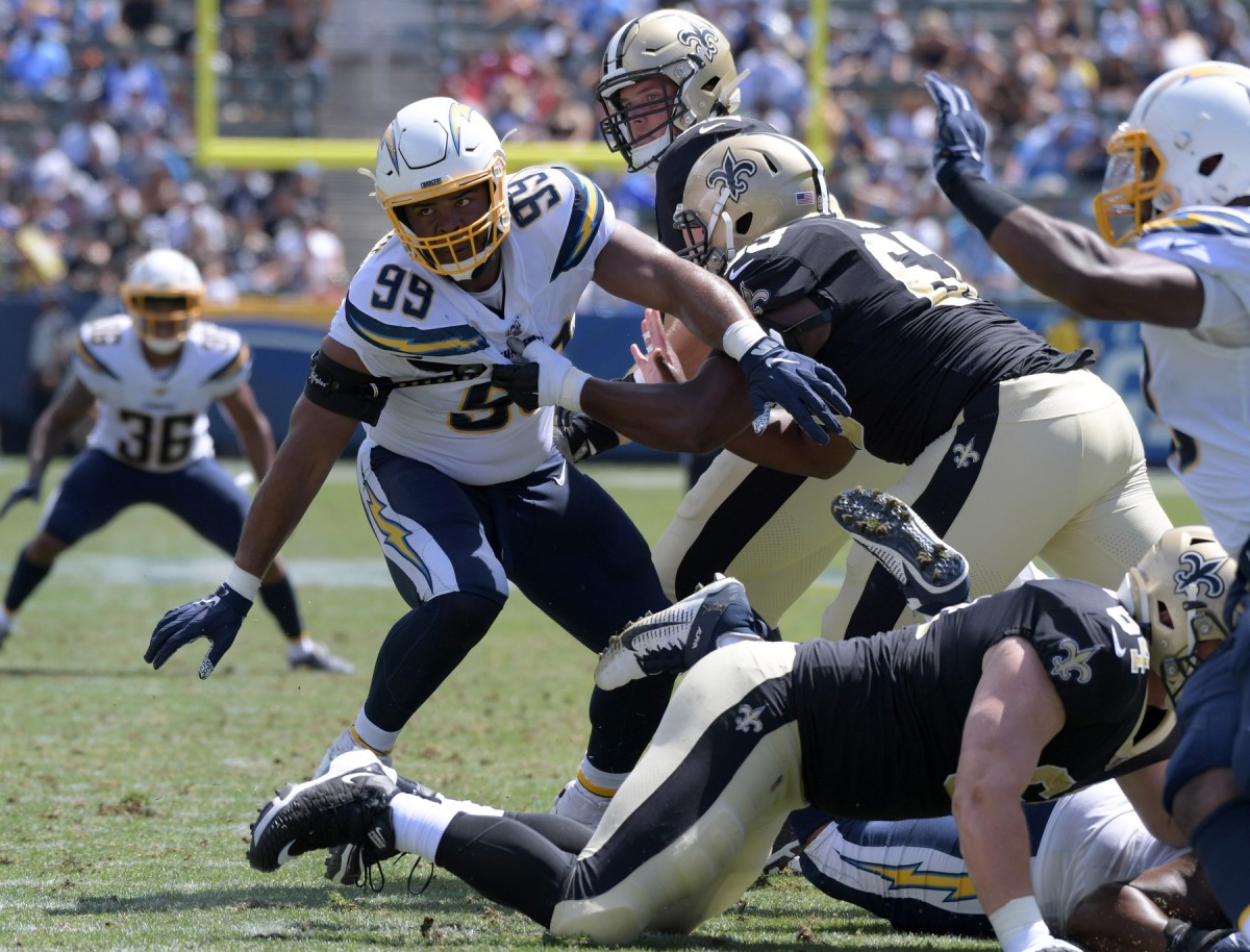 Aug 18, 2019; Carson, CA, USA; Los Angeles Chargers defensive tackle Jerry Tillery (99) attempts to get past New Orleans Saints center Cameron Tom (63) at Dignity Health Sports Park. The Saints defeated the Chargers 19-17. Mandatory Credit: Kirby Lee-USA TODAY Sports