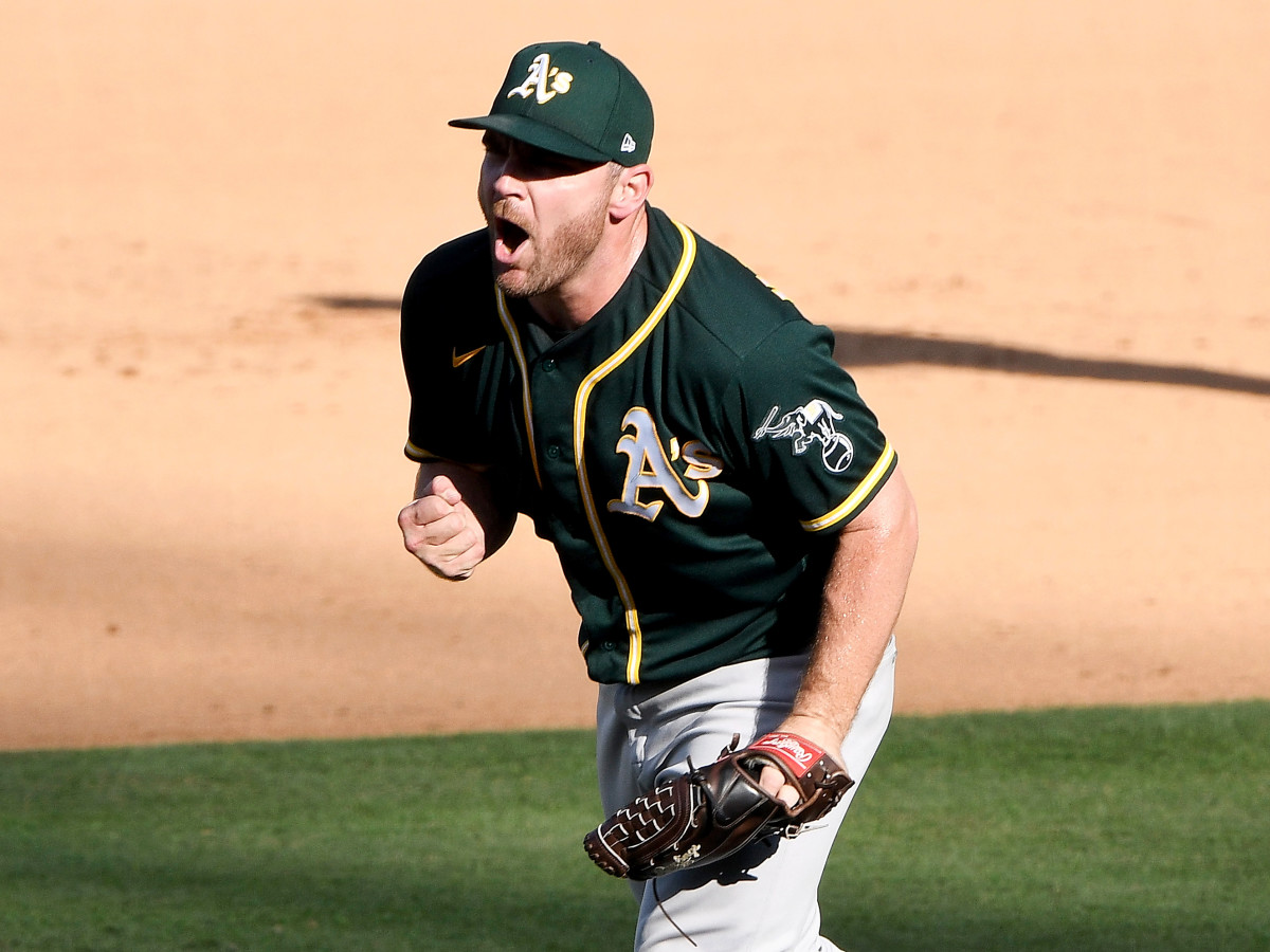 Oct 7, 2020; Los Angeles, California, USA; Oakland Athletics relief pitcher Liam Hendriks (16) celebrates after the Athletics defeated the Houston Astros in game three of the 2020 ALDS at Dodger Stadium.