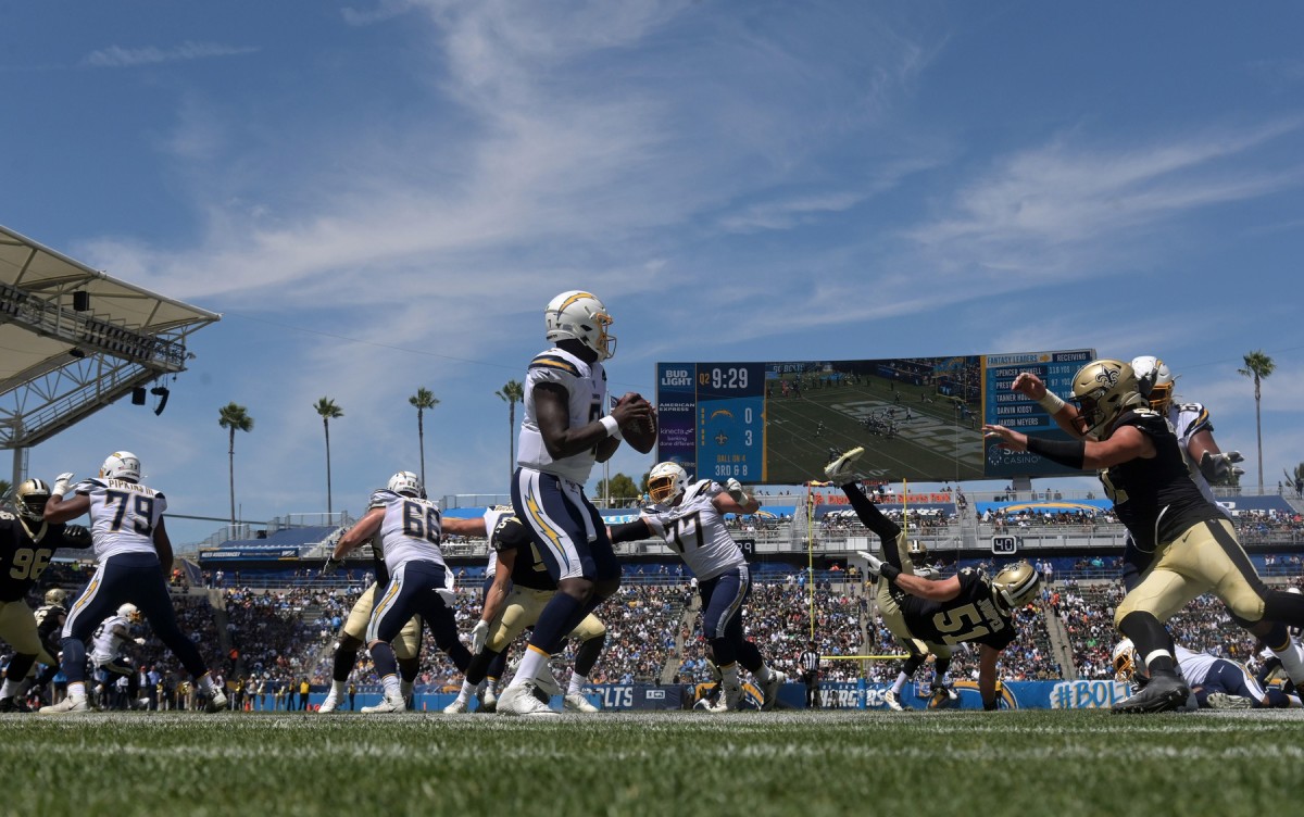 Aug 18, 2019; Carson, CA, USA; Los Angeles Chargers quarterback Cardale Jones (7) throws a pass under pressure from New Orleans Saints defensive end Trey Hendrickson (91) at Dignity Health Sports Park. The Saints defeated the Chargers 19-17. Mandatory Credit: Kirby Lee-USA TODAY