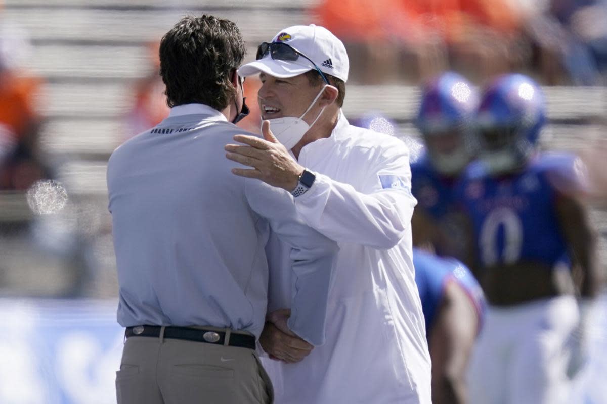 Miles and Gundy hugged prior to the game in Lawrence last Saturday.