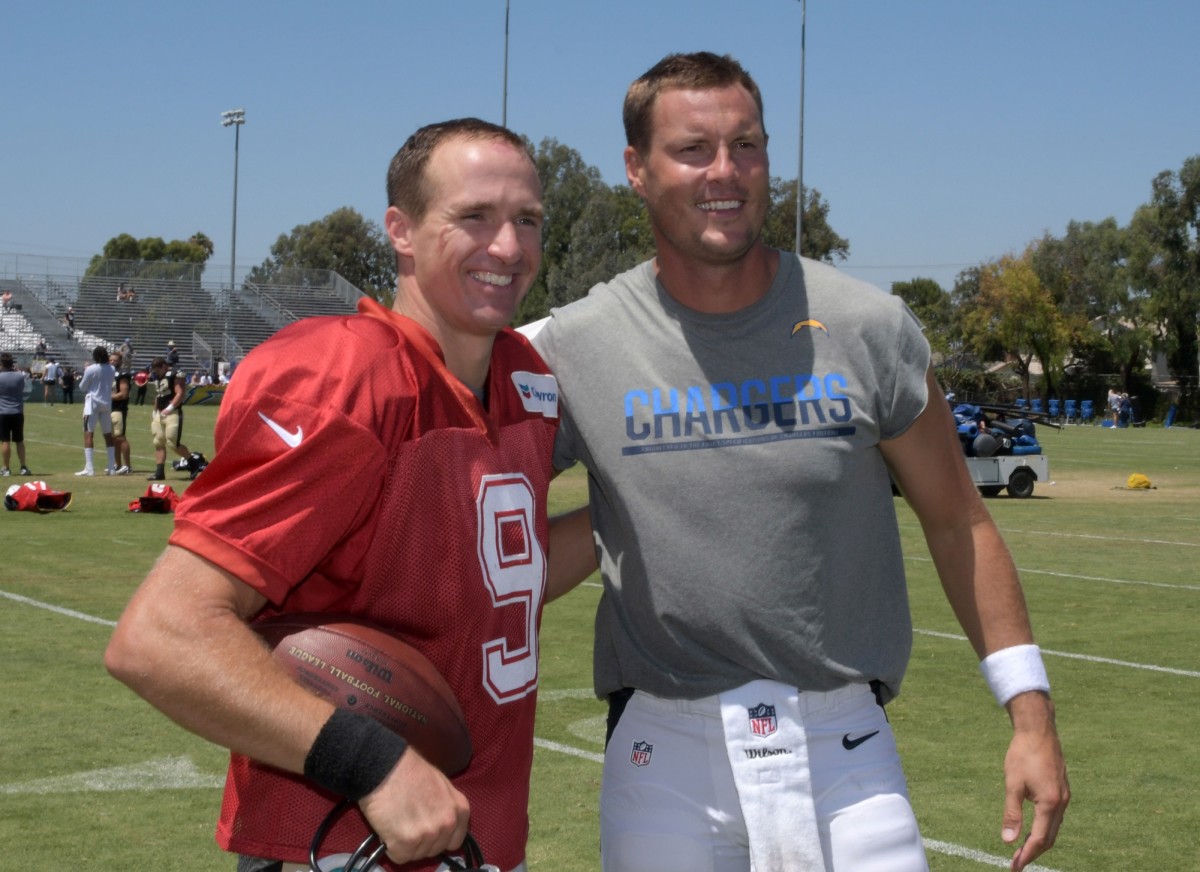 Aug 17, 2017; Costa Mesa, CA, USA; New Orleans Saints quarterback Drew Brees (9) and Los Angeles Chargers quarterback Philip Rivers pose during practice at the Jack Hammett Sports Complex. Mandatory Credit: Kirby Lee-USA TODAY Sports