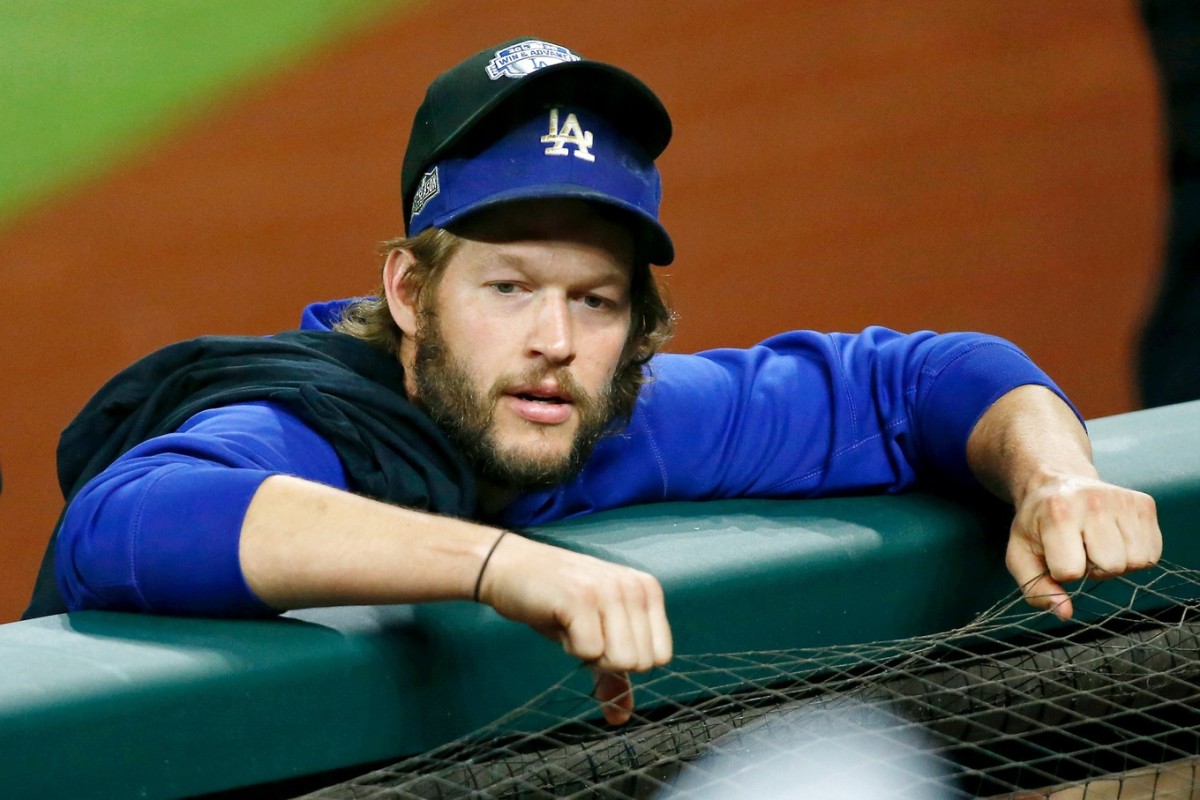 Oct 8, 2020; Arlington, Texas, USA; Los Angeles Dodgers starting pitcher Clayton Kershaw (22) wears an NLDS hat over his team hat after their win over the San Diego Padres after game three of the 2020 NLDS at Globe Life Field. The Los Angeles Dodgers won 12-3 to sweep the San Diego Padres. Mandatory Credit: Tim Heitman-USA TODAY Sports