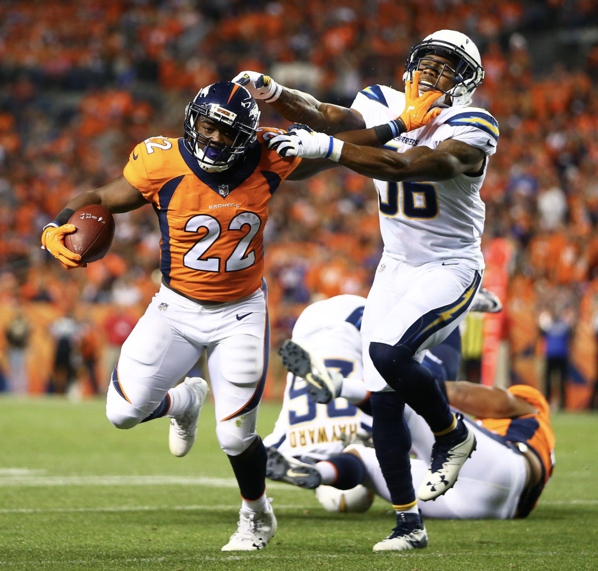 C.J. Anderson fends off a Chargers would-be tackler.