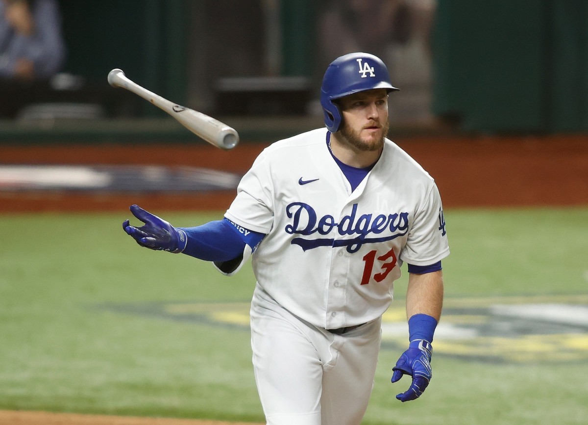 Oct 13, 2020; Arlington, Texas, USA; Los Angeles Dodgers first baseman Max Muncy (13) tosses his bat after hitting a two run home run during the ninth inning against the Atlanta Braves in game two of the 2020 NLCS at Globe Life Field. Mandatory Credit: Tim Heitman-USA TODAY Sports