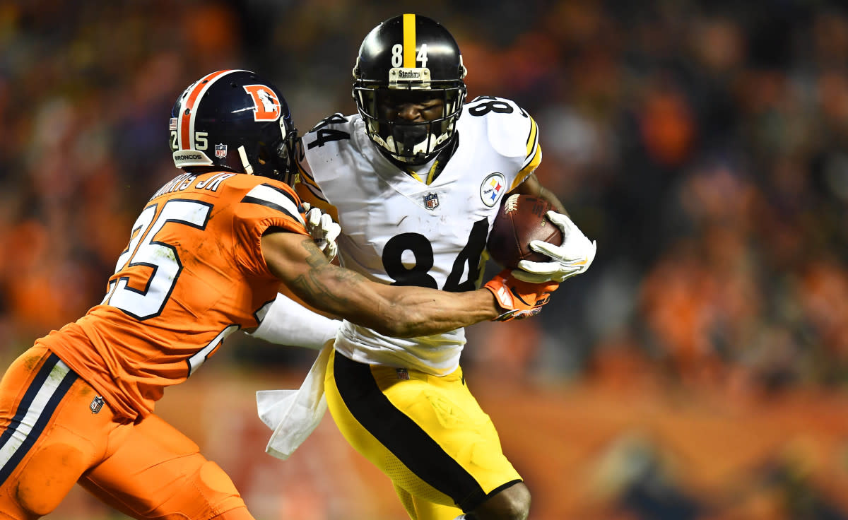 Steelers wide receiver Antonio Brown (84) is tackled after a reception Broncos cornerback Chris Harris (25) in the second half at Broncos Stadium at Mile High. 