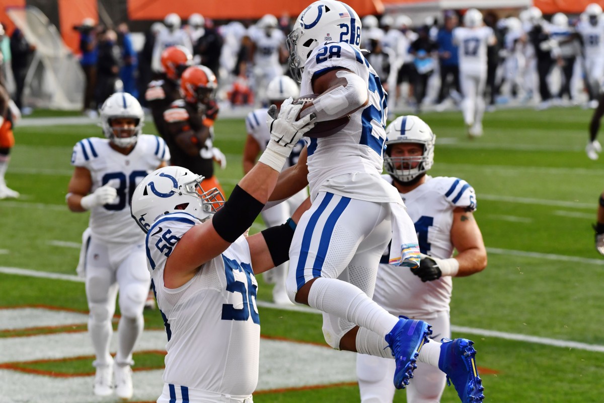 Indianapolis Colts offensive guard Quenton Nelson (56) lifts rookie running back Jonathan Taylor after a TD rush on Sunday at Cleveland.