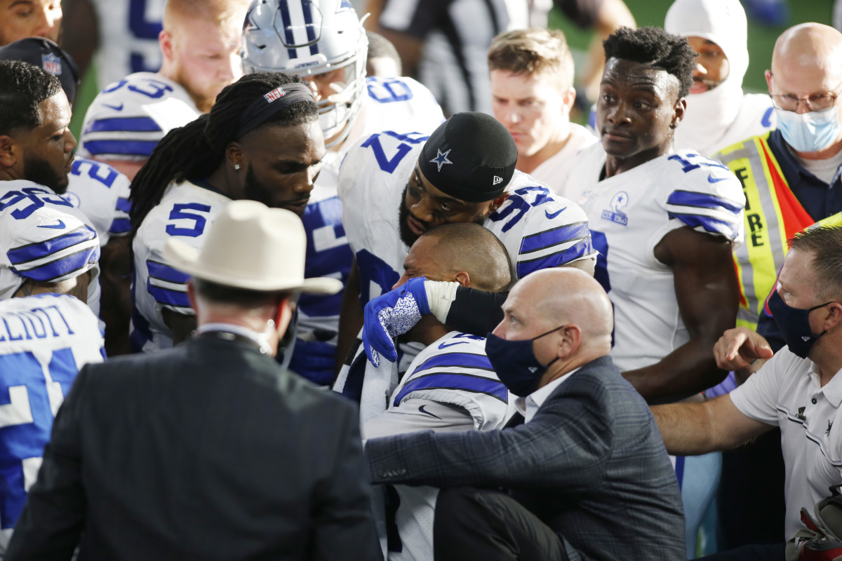 Cowboys quarterback Dak Prescott is comforted by his teammates after an injury in the third quarter against the New York Giants.
