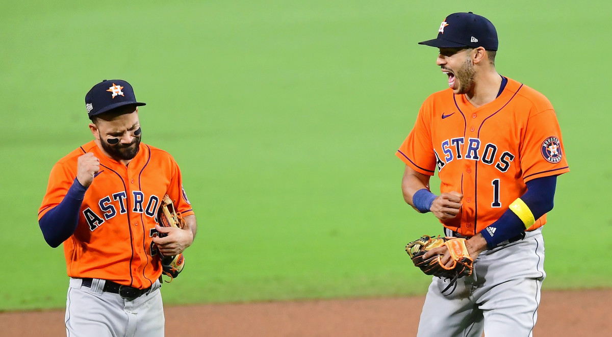 Houston Astros second baseman Jose Altuve (27) and shortstop Carlos Correa (1) celebrate their win over the Tampa Bay Rays after game six of the 2020 ALCS at Petco Park. The Houston Astros won 7-4.