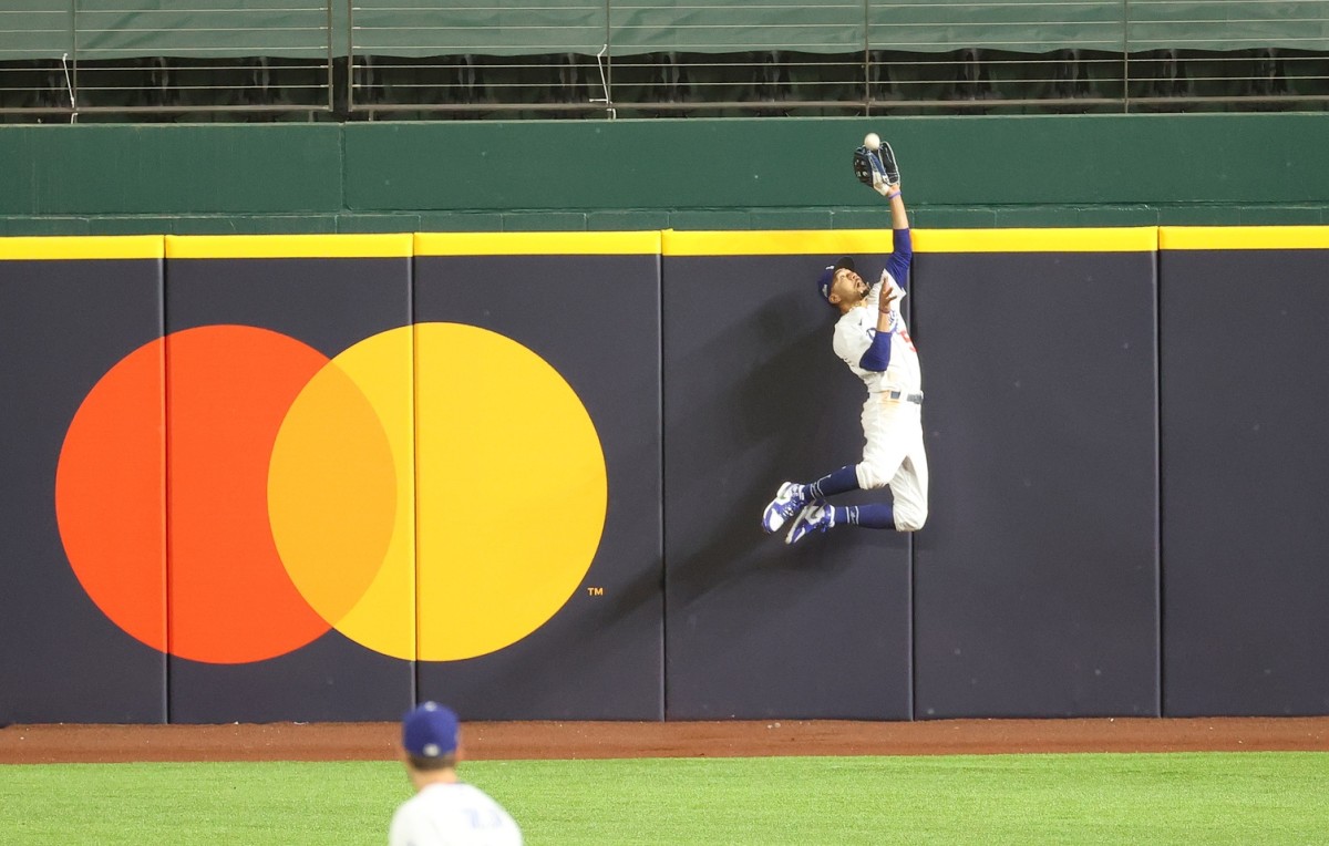 Oct 18, 2020; Arlington, Texas, USA; Los Angeles Dodgers right fielder Mookie Betts (50) makes a catch against Atlanta Braves right fielder Ronald Acuna Jr. (not pictured) in the fifth inning during game seven of the 2020 NLCS at Globe Life Field. Mandatory Credit: Kevin Jairaj-USA TODAY Sports
