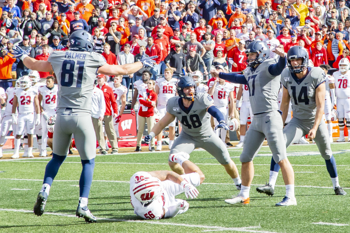Illinois Fighting Illini place kicker James McCourt (17) celebrates with teammates after kicking the game winning field goal during the second half against the Wisconsin Badgers at Memorial Stadium.