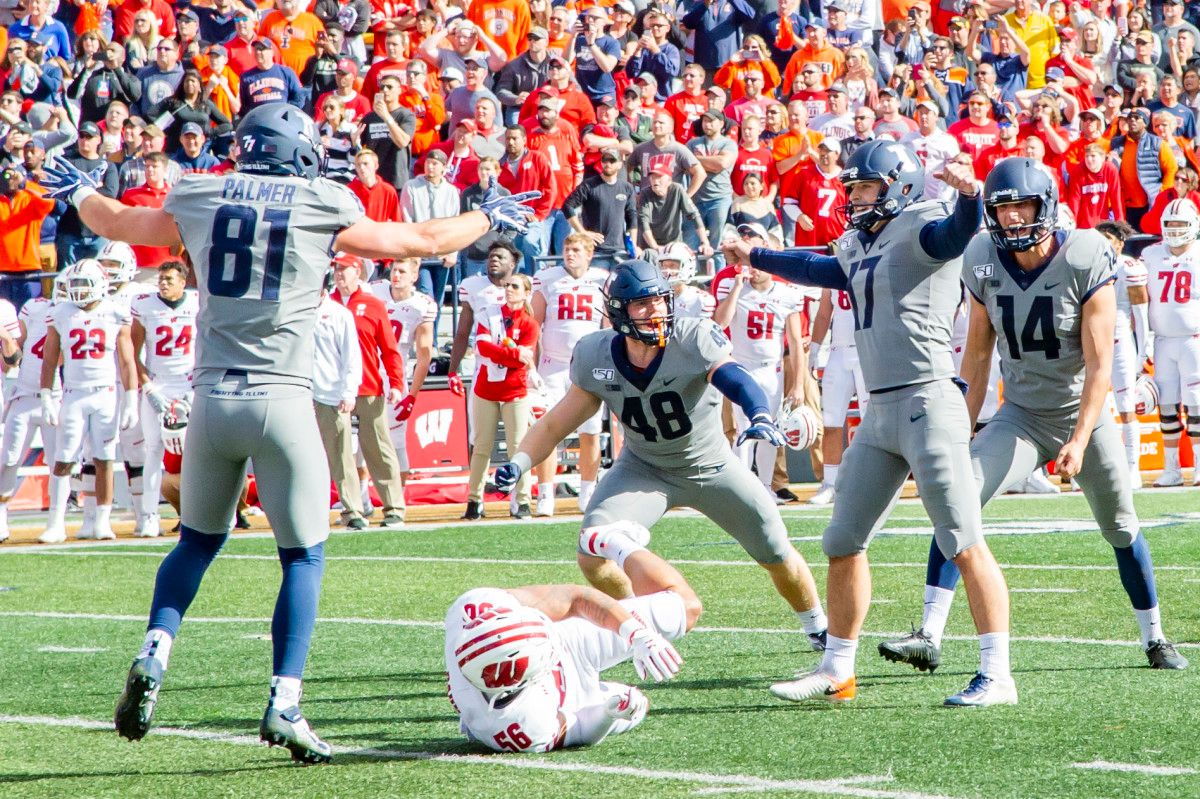 Illinois Fighting Illini place kicker James McCourt (17) celebrates with teammates after kicking the game winning field goal during the second half against the Wisconsin Badgers at Memorial Stadium.