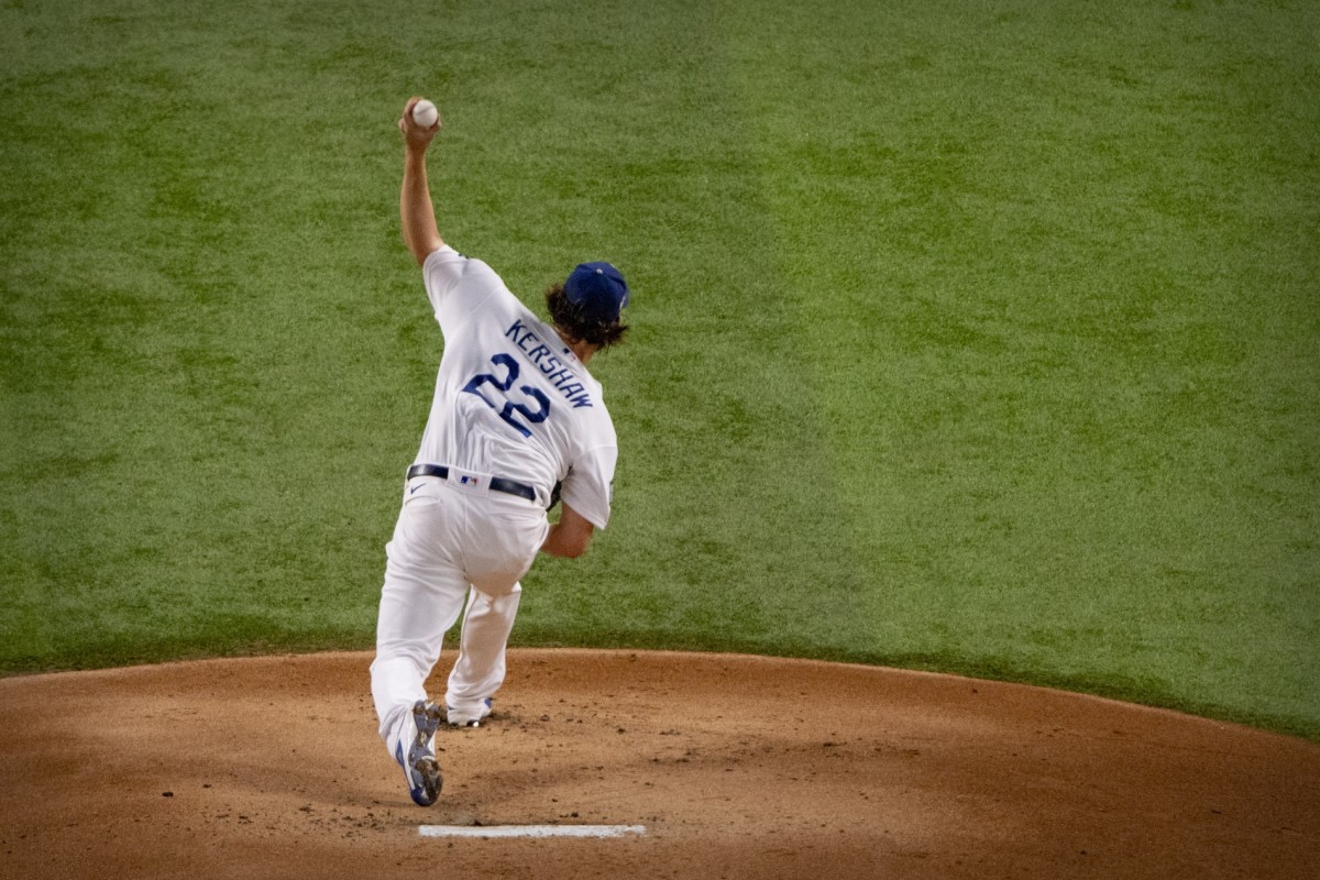 Oct 20, 2020; Arlington, Texas, USA; Los Angeles Dodgers starting pitcher Clayton Kershaw (22) pitches against the Tampa Bay Rays during the first inning in game one of the 2020 World Series at Globe Life Field. Mandatory Credit: Jerome Miron-USA TODAY Sports