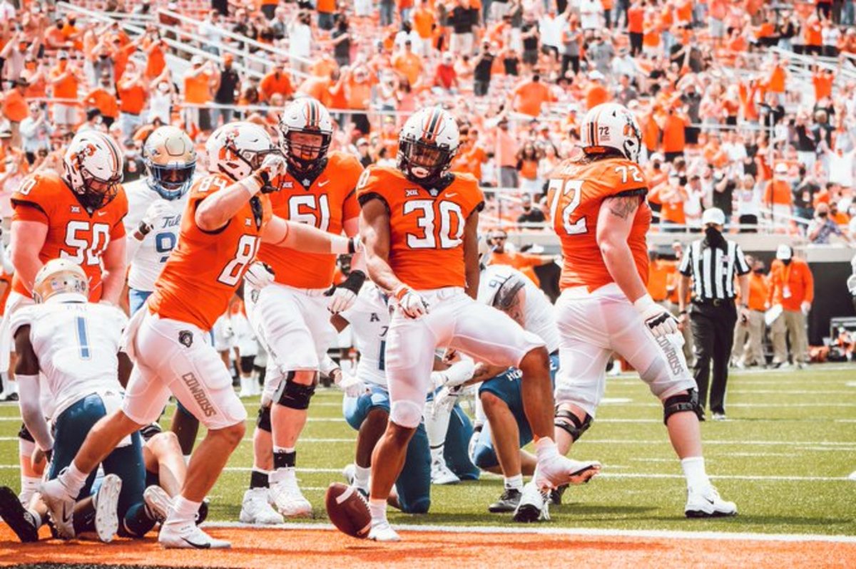 Jake Springfield (61) celebrates with the offensive line for the Chuba Hubbard touchdown against Tulsa. It was Springfield's second game appearance as he played in mop up time against McNeese State as a freshman.