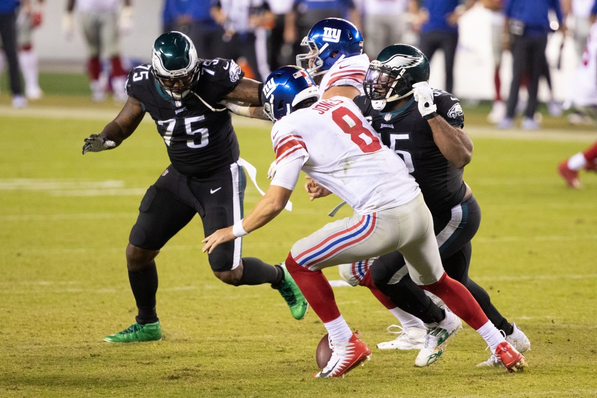 Oct 22, 2020; Philadelphia, Pennsylvania, USA; New York Giants quarterback Daniel Jones (8) fumbles the ball while in front of the rush of Philadelphia Eagles defensive end Vinny Curry (75) and defensive end Brandon Graham (55) during the fourth quarter at Lincoln Financial Field.