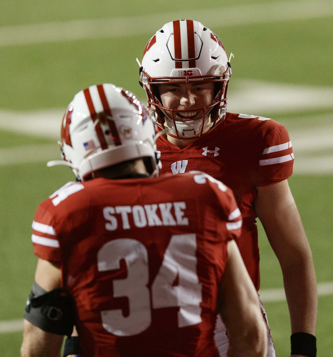 Wisconsin Badgers quarterback Graham Mertz (5) celebrates with fullback Mason Stokke (34) following a touchdown during the first quarter against the Illinois Fighting Illini at Camp Randall Stadium.