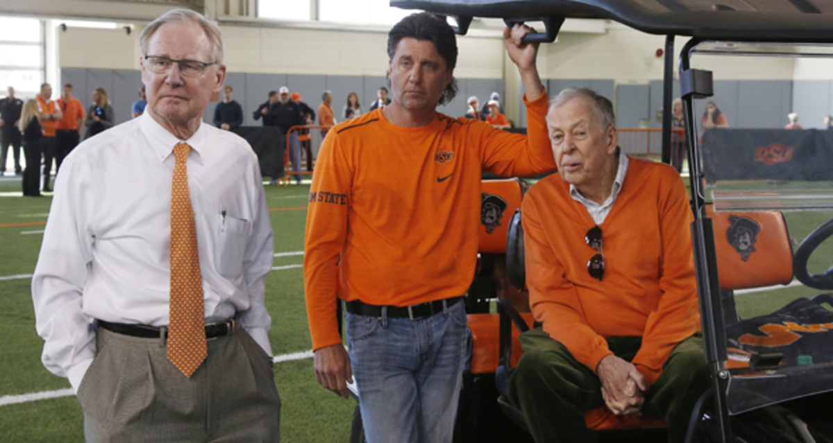 President Hargis with head football coach Mike Gundy and T. Boone Pickens (seated) watching Oklahoma State players on Pro Day 2018 inside the Sherman Smith Training Center.