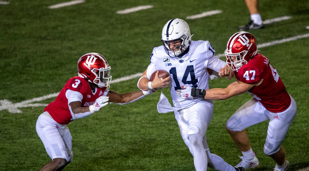 Penn State Nittany Lions quarterback Sean Clifford (14) attempts to avoid tackle from Indiana Hoosiers linebacker Micah McFadden (47) and Indiana Hoosiers defensive back Tiawan Mullen (3) late in the second half of the game at Memorial Stadium.