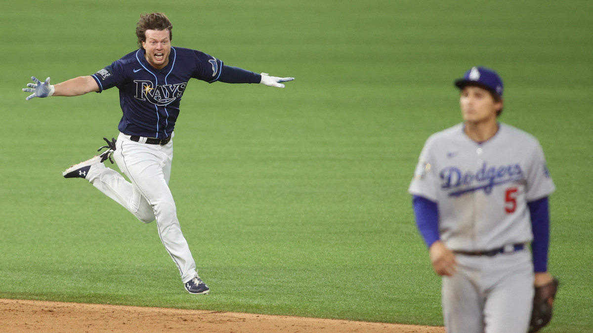 Tampa Bay Rays right fielder Brett Phillips (14) celebrates after driving in the winning run as Los Angeles Dodgers shortstop Corey Seager (5) looks on during the ninth inning of game four