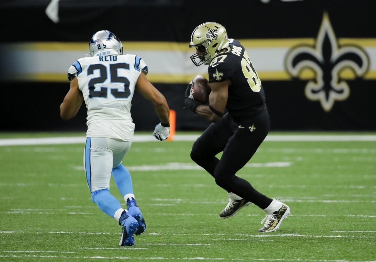 Nov 24, 2019; New Orleans, LA, USA; New Orleans Saints tight end Jared Cook (87) breaks a tackle by Carolina Panthers strong safety Eric Reid (25) during the first half at the Mercedes-Benz Superdome. Mandatory Credit: Derick E. Hingle-USA TODAY