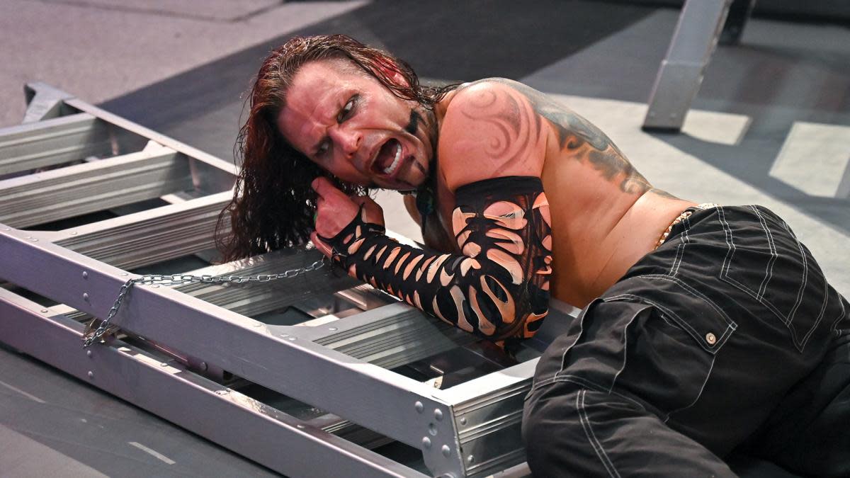 Jeff Hardy_courtesy WWE_ear hooked on ladder