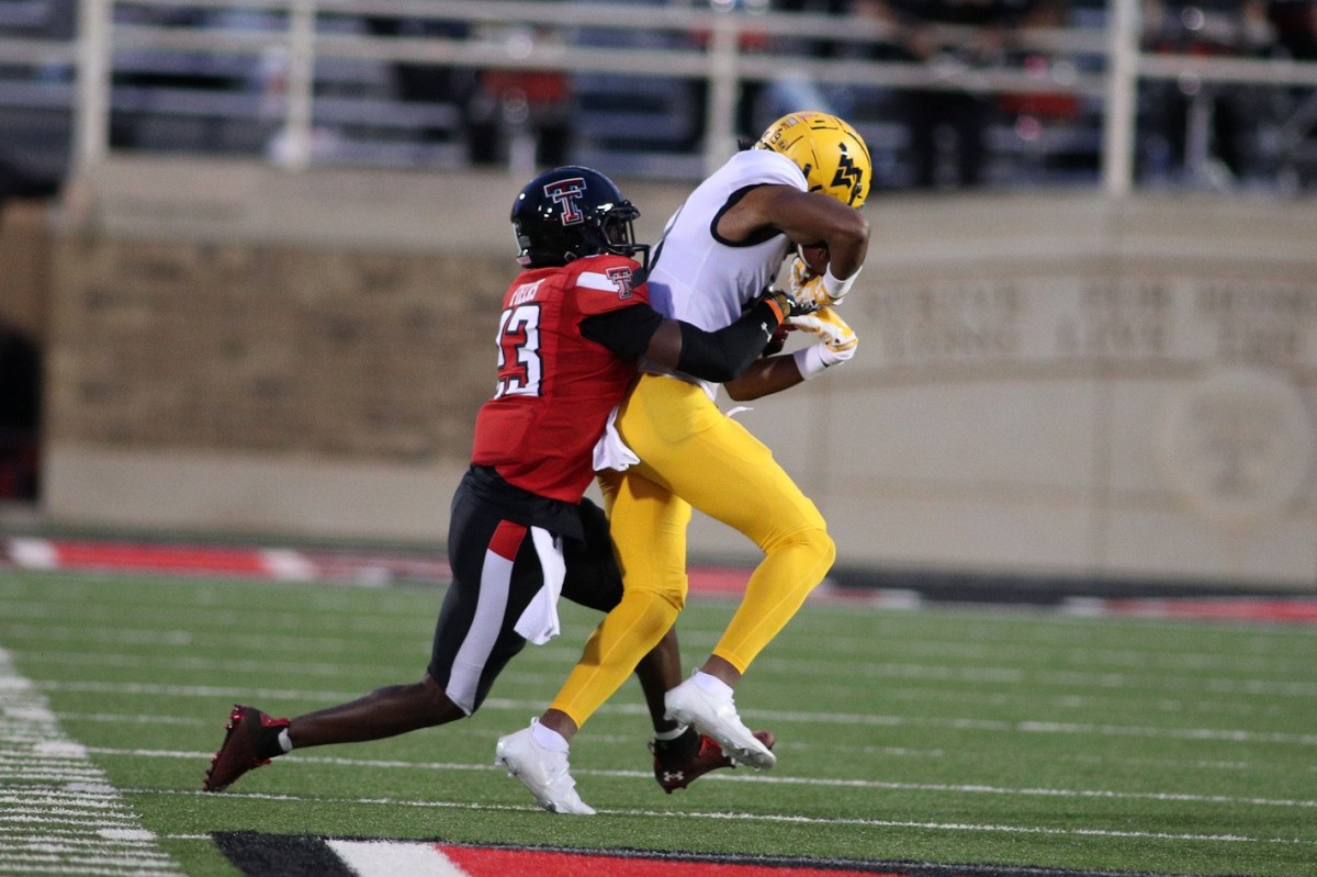 West Virginia Mountaineers wide receiver Ali Jennings (19) is tackled by Texas Tech Red Raiders defensive back DeMarcus Fields (23) in the fourth quarter at Jones AT&T Stadium.
