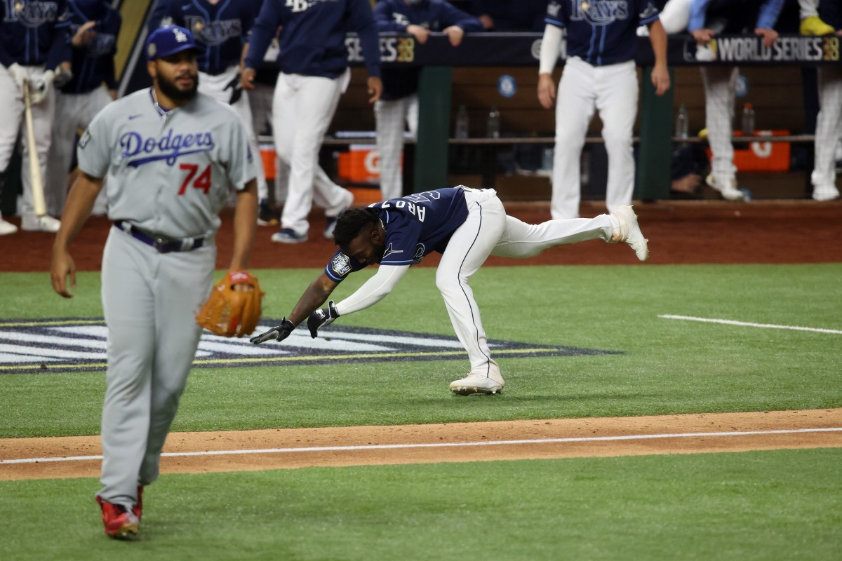 Oct 24, 2020; Arlington, Texas, USA; Tampa Bay Rays designated hitter Randy Arozarena (56) stumbles before scoring the winning run as Los Angeles Dodgers relief pitcher Kenley Jansen (74) looks on during the ninth inning of game four of the 2020 World Series at Globe Life Field. Mandatory Credit: Tim Heitman-USA TODAY Sports