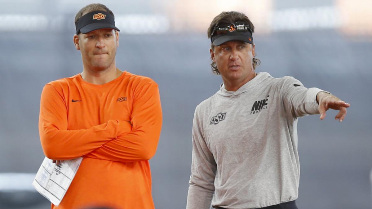 Mike Gundy points out something in practice to Mike Yurcich at a bowl practice when Yurcich was offensive coordinator for Gundy at Oklahoma State.