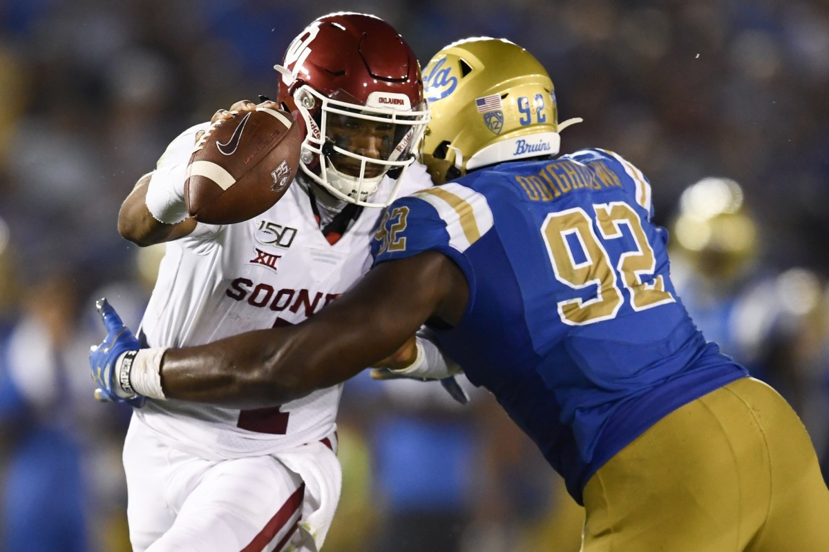 Sep 14, 2019; Pasadena, CA, USA; Oklahoma Sooners quarterback Jalen Hurts (1) moves the ball while UCLA Bruins defensive lineman Osa Odighizuwa (92) defends during the second half at Rose Bowl.