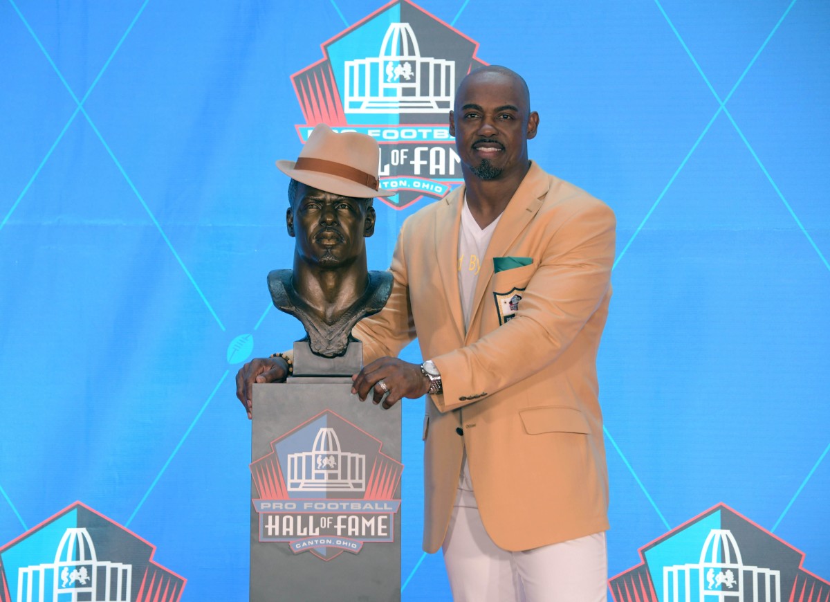 Former safety Brian Dawkins poses with bust during the Pro Football Hall of Fame Enshrinement Ceremony at Tom Bensen Stadium. 