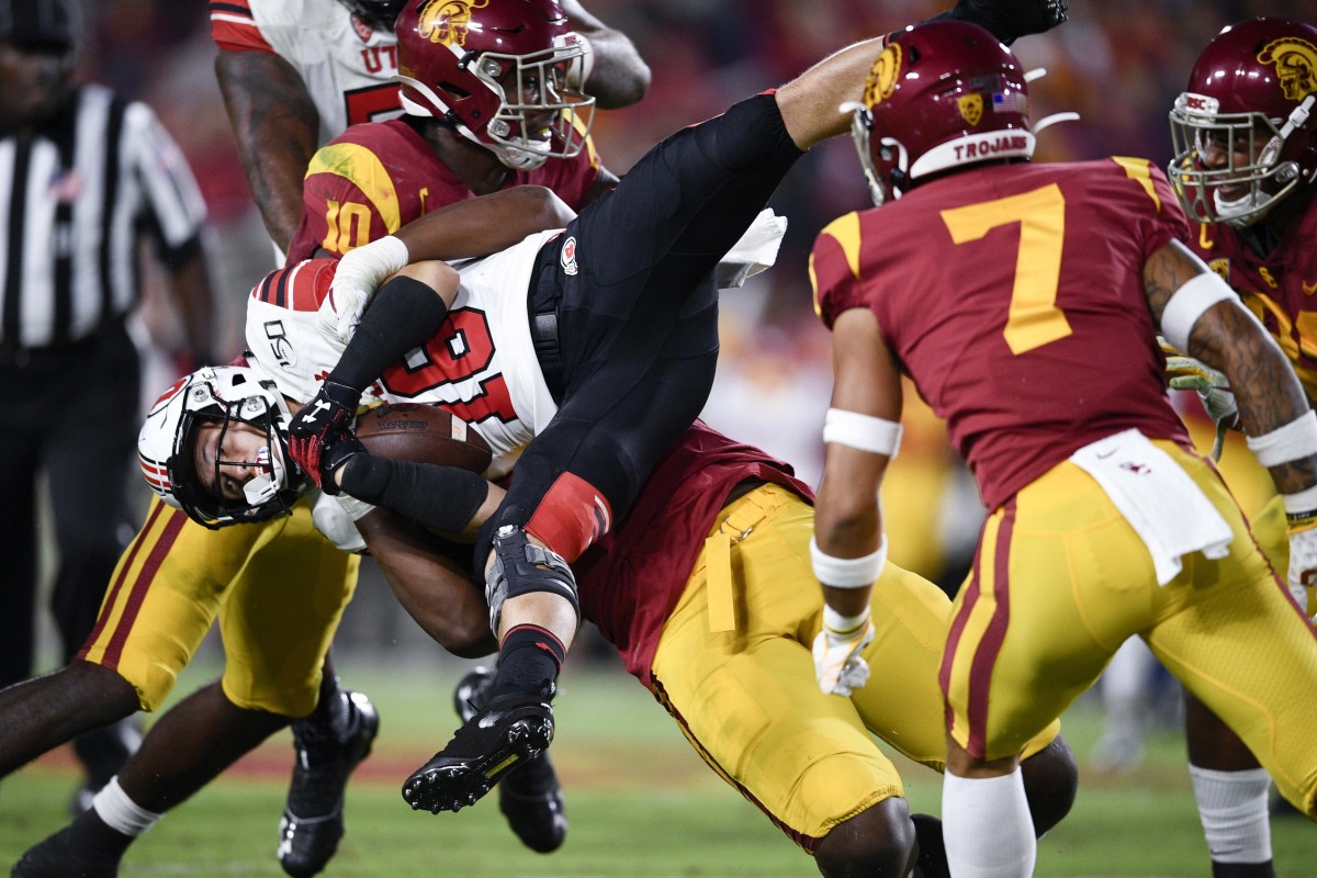 Sep 20, 2019; Los Angeles, CA, USA; Southern California Trojans defensive lineman Drake Jackson (99) tackles Utah Utes wide receiver Britain Covey (18) resulting in a penalty during the first half at Los Angeles Memorial Coliseum.