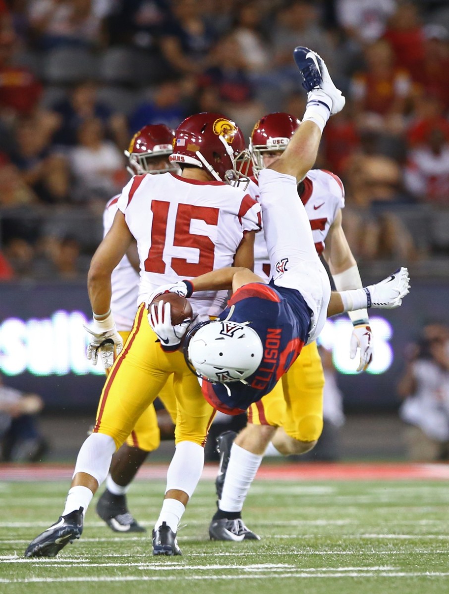 Sep 29, 2018; Tucson, AZ, USA; Arizona Wildcats wide receiver Tony Ellison (9) is upended by Southern California Trojans safety Talanoa Hufanga (15) in the first half at Arizona Stadium.
