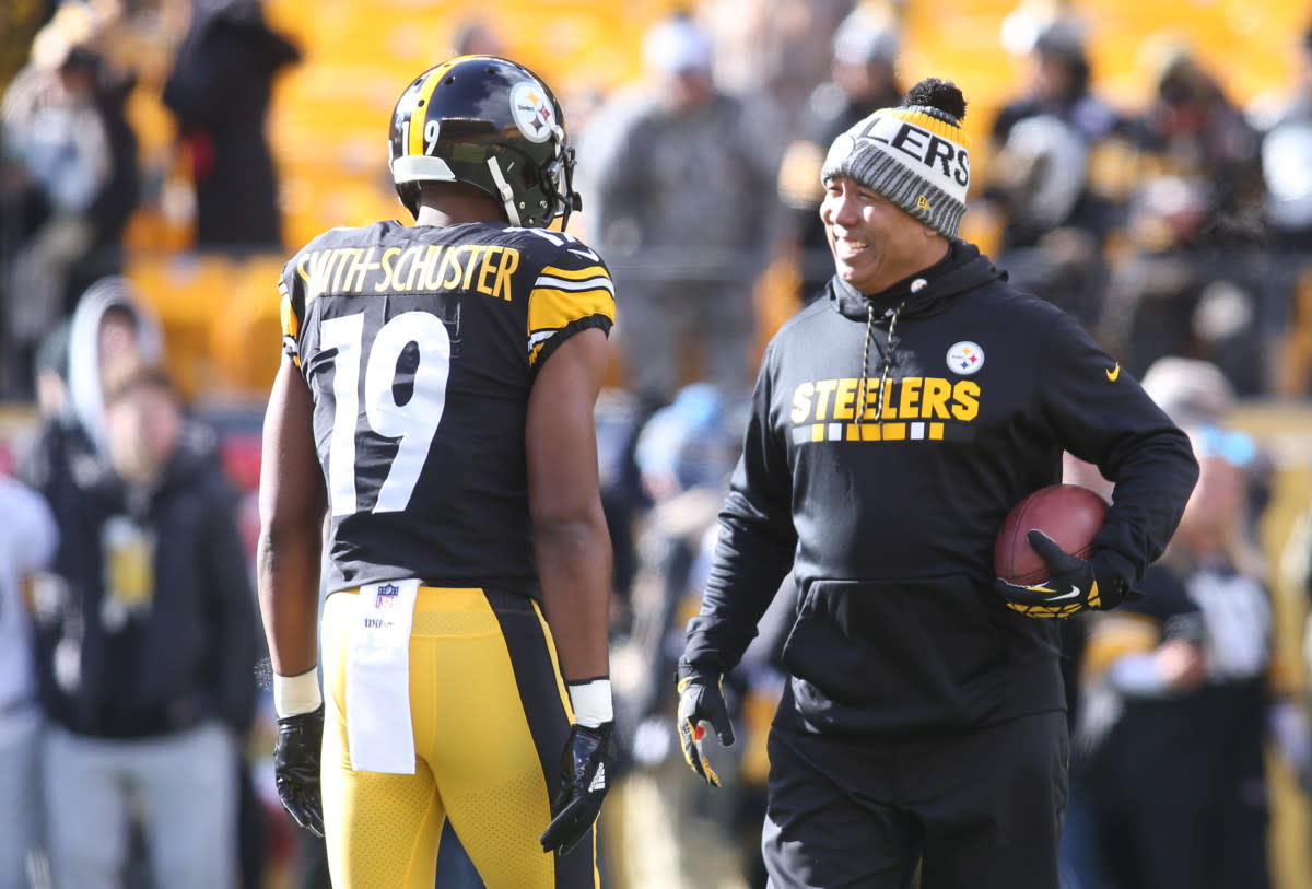 Steelers wide receiver JuJu Smith-Schuster (19) talks with former receiver Hines Ward before playing the Jaguars in the 2018 AFC Divisional Playoff game at Heinz Field.