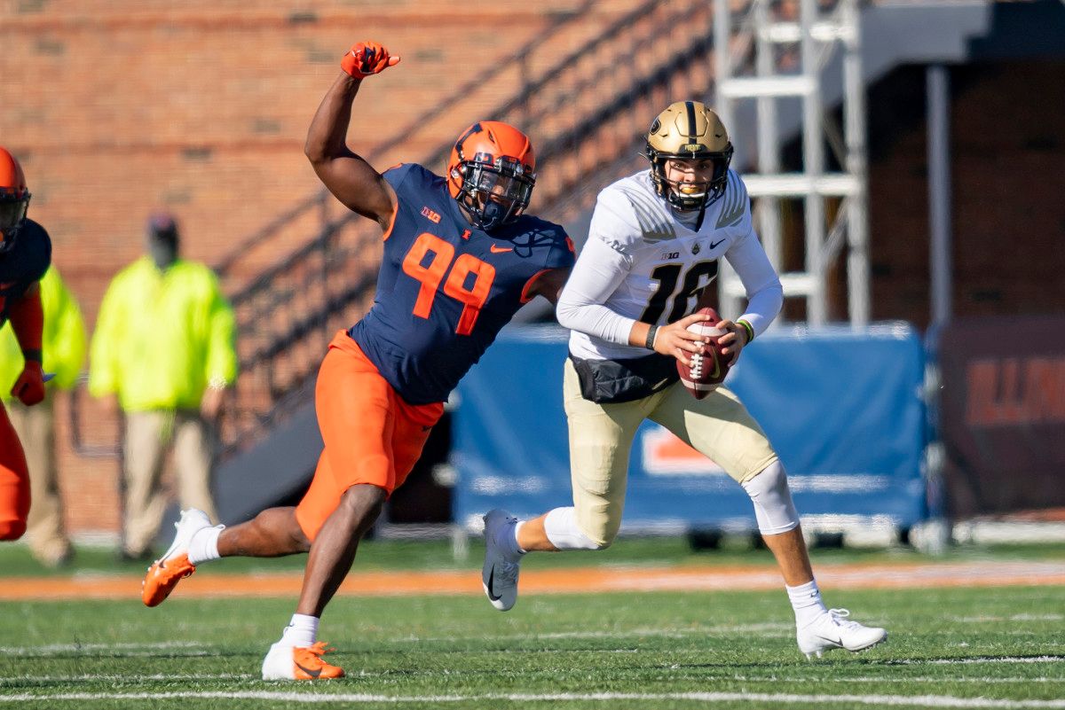 Illinois Fighting Illini defensive lineman Owen Carney Jr. (99) sacks Purdue Boilermakers quarterback Aidan O'Connell (16) during the second half at Memorial Stadium. Carney Jr., had three sacks Saturday in a 31-24 loss to Purdue.