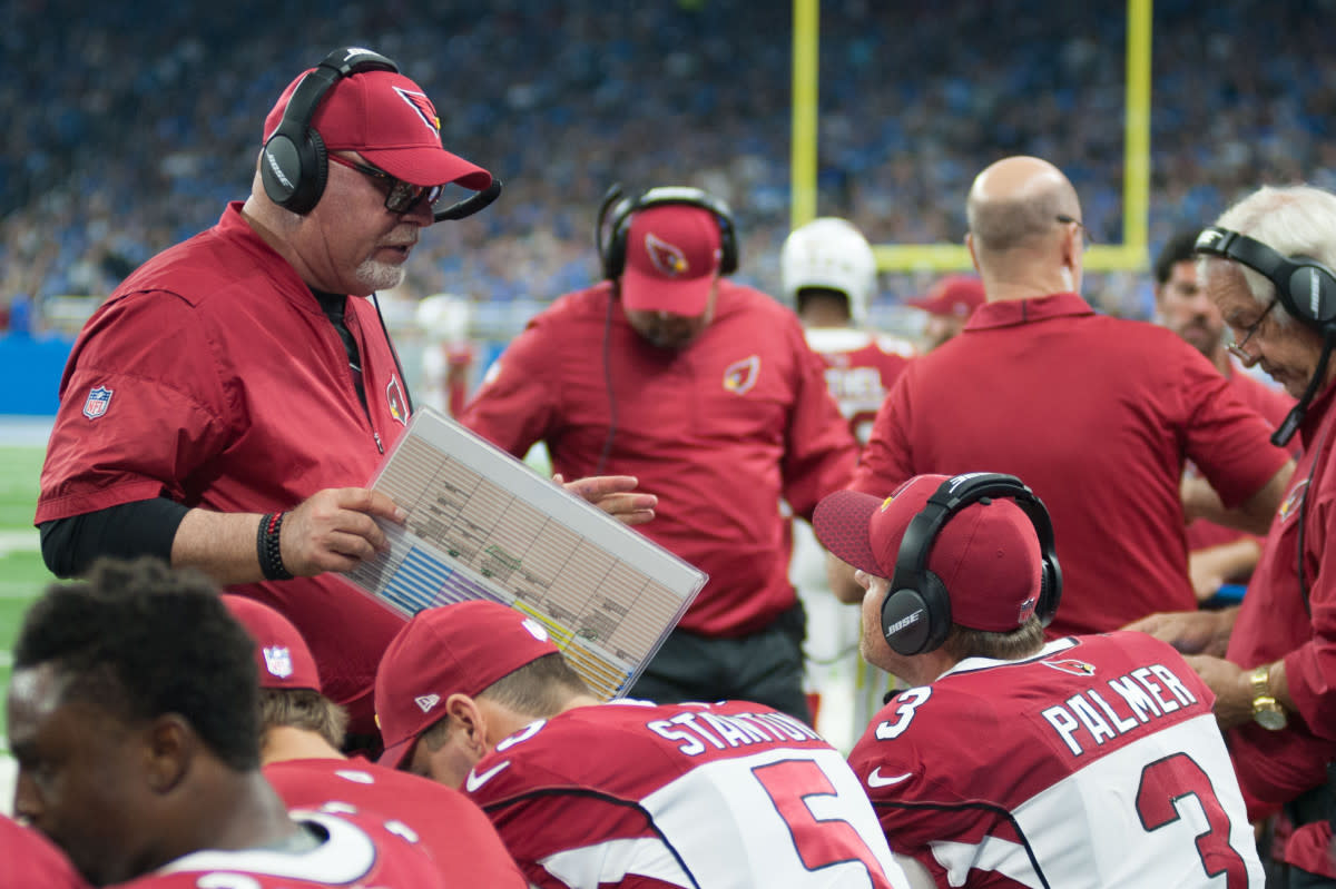 Former Cardinals head coach Bruce Arians talks to quarterback Carson Palmer (3), during a 2017 game against the Lions.