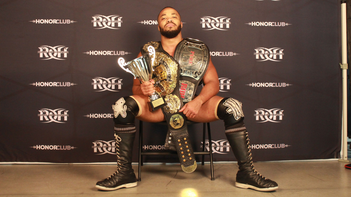 Ring of Honor wrestler Jonathan Gresham poses with his championship belts