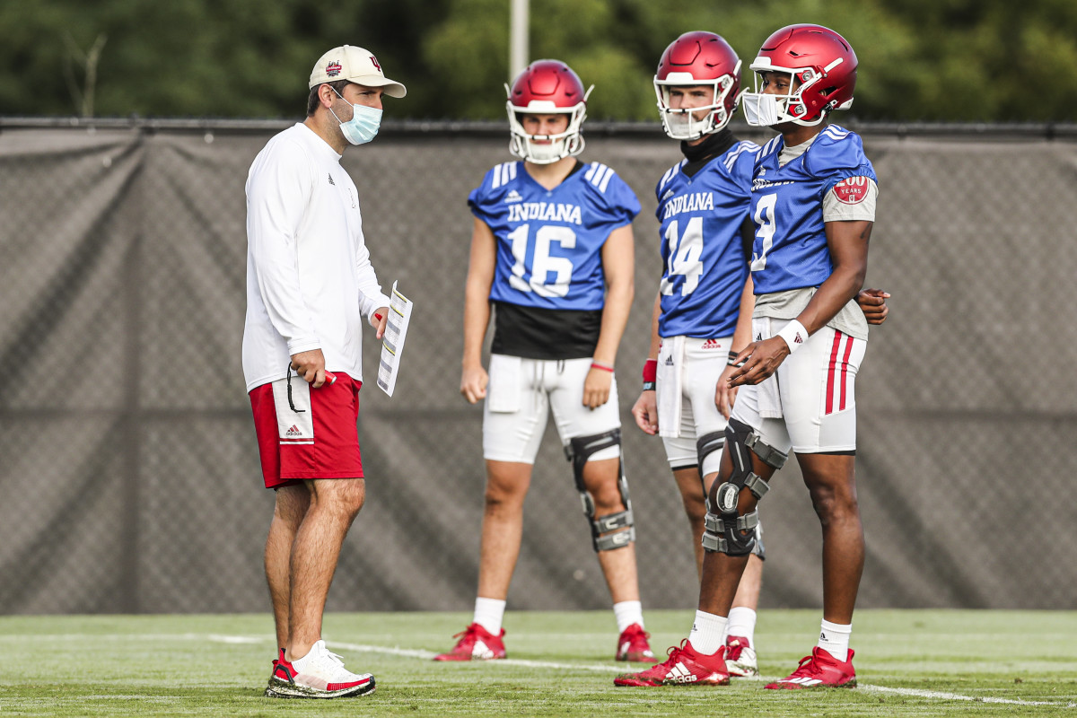 Indiana offensive coordinator Nick Sheridan (left) chats with his quarterbacks during a recent practice. (Photo courtesy IU Athletics)