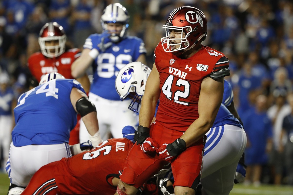 Aug 29, 2019; Provo, UT, USA; Utah Utes defensive end Mika Tafua (42) reacts to a sack on Brigham Young Cougars quarterback Zach Wilson (1) in the second quarter at LaVell Edwards Stadium.