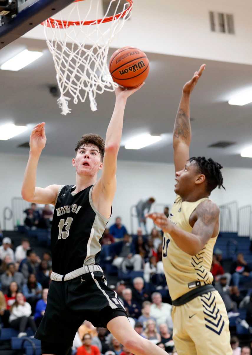 Arlington's Madison Peaster (11) tries to block Houston's Mason Miller (13) as he goes up at the net Monday, March 9, 2020, during the Division I Class AAA substate game at Arlington High School.
