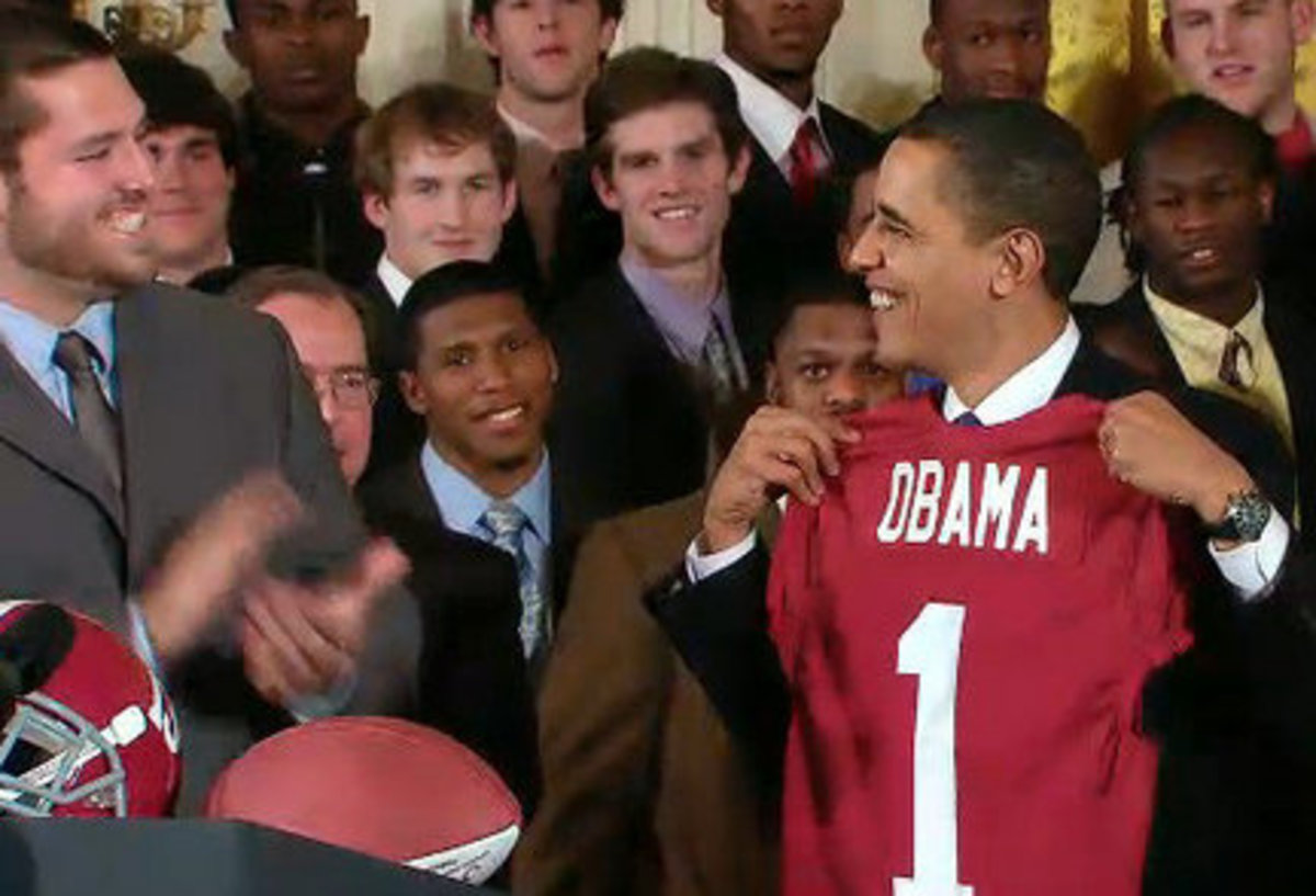 Mike Johnson presents President Obama with a Crimson Tide jersey at the White House