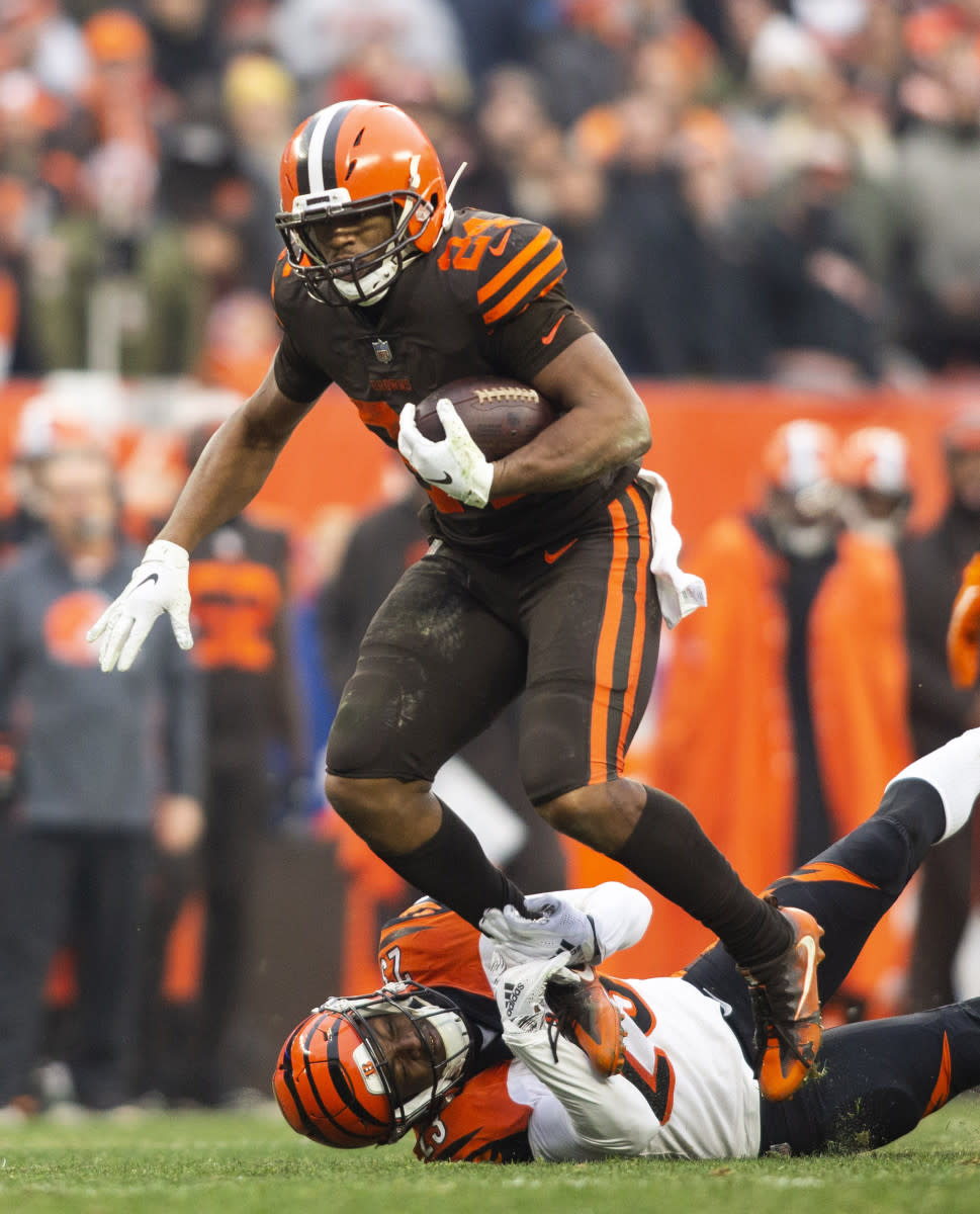 Browns running back Nick Chubb (24) breaks a tackle from Bengals cornerback Darius Phillips (23) during the third quarter at FirstEnergy Stadium in Cleveland, Dec. 23, 2018.