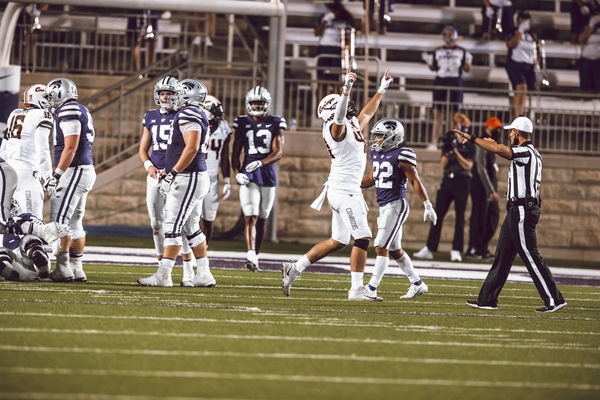 Oklahoma State defensive end Brock Martin, hands raised, celebrates another big play when he got a finger in and forced K-State's Howard to fumble before he could throw a pass on a two-point conversion attempt.